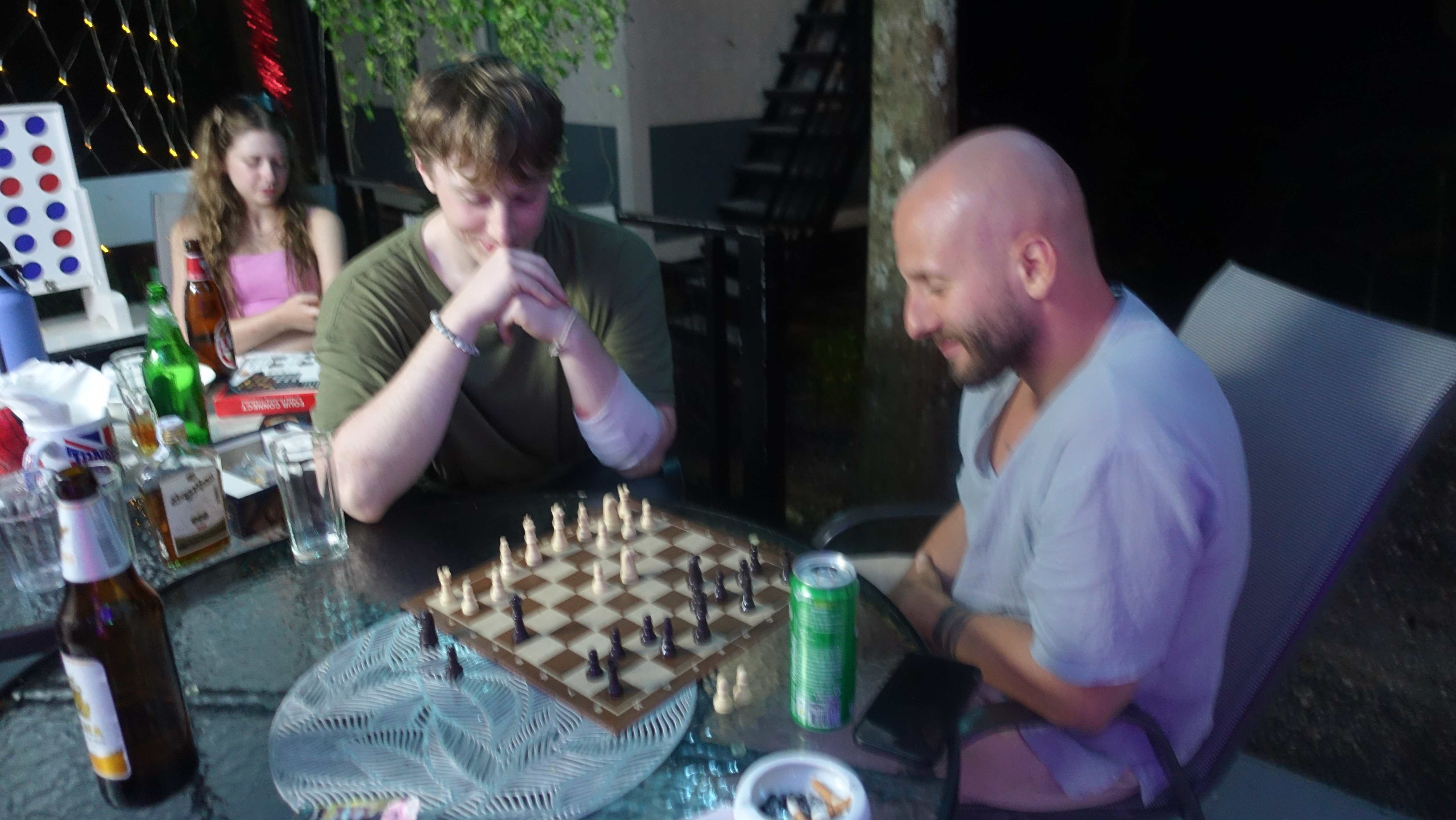 Guests playing chess on the terrace in the evening