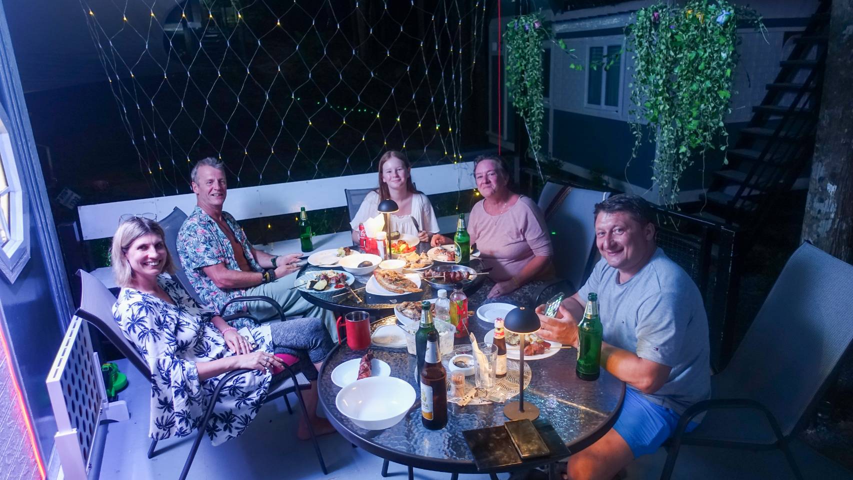Group of friends sharing a meal on the outdoor terrace