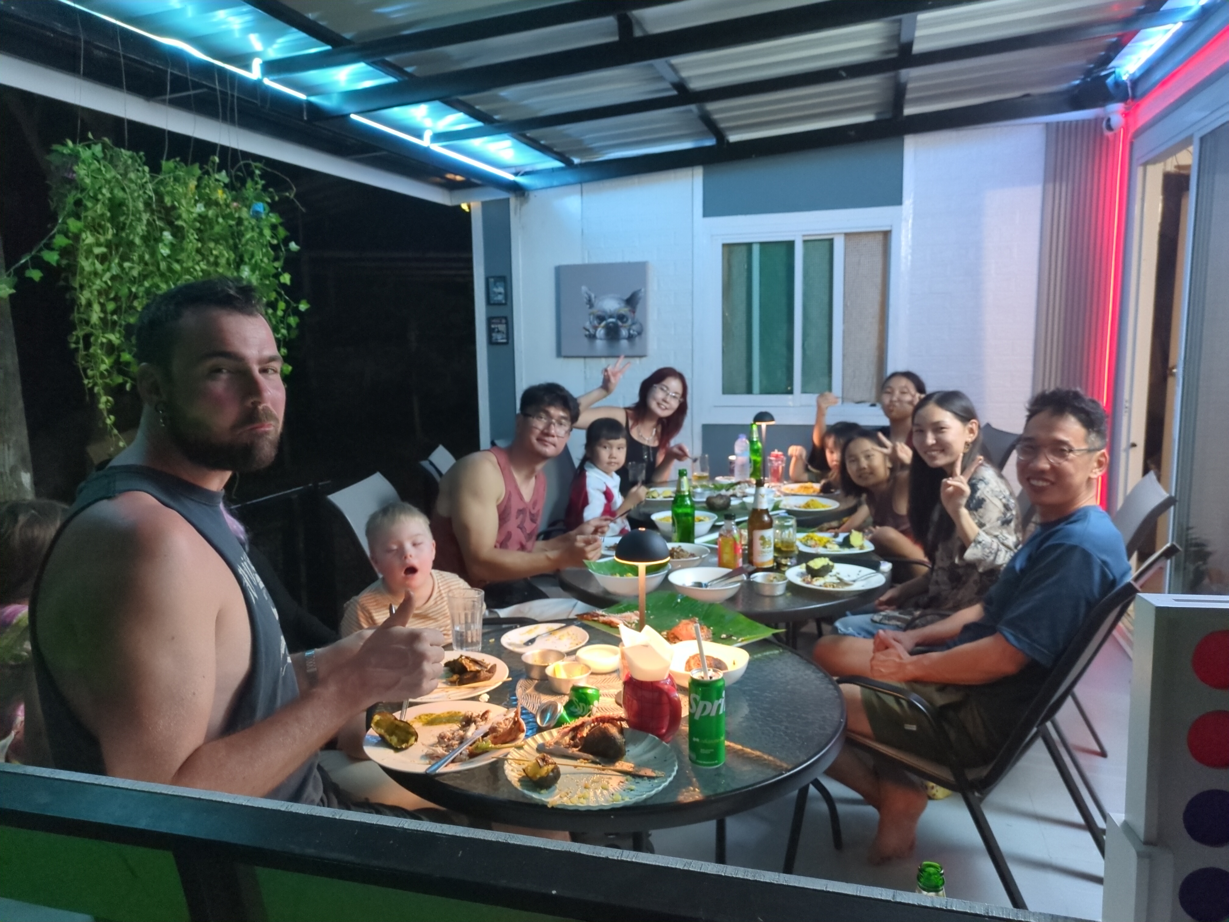 Big group of guests dining together on the covered terrace