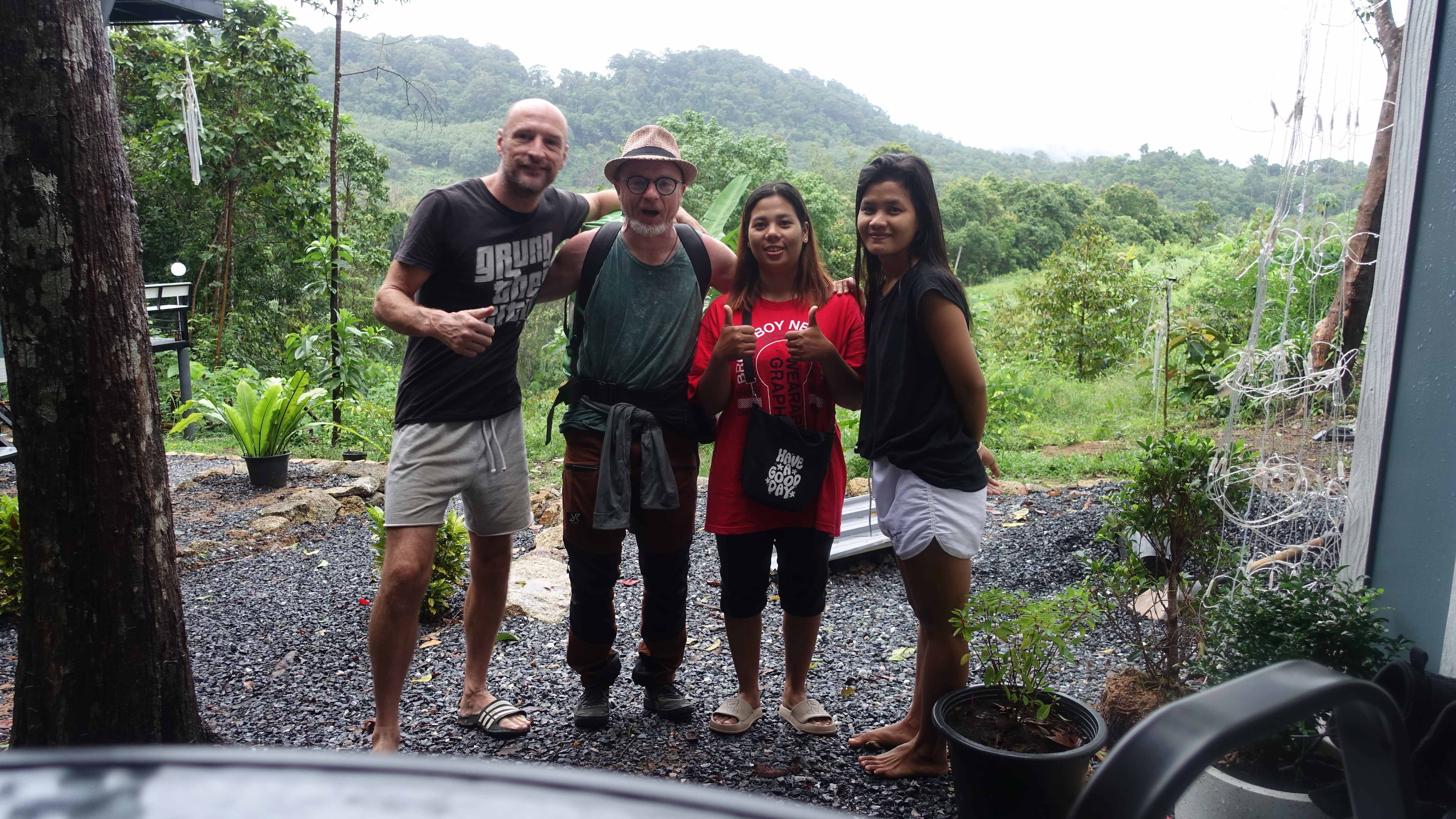 Guests posing together with tropical vegetation backdrop