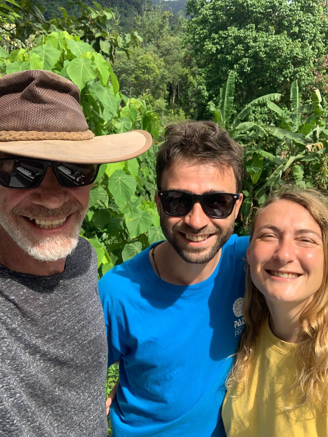 Three guests taking a selfie in the tropical setting
